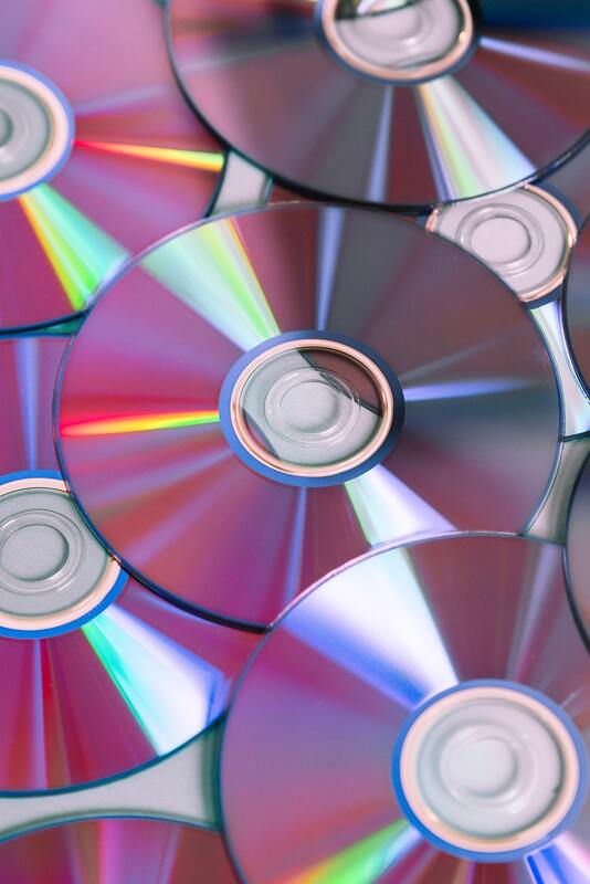 An assortment of CDs spread out on a desk.