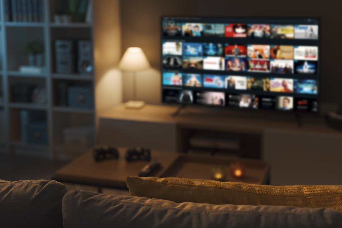 Modern living room with popular streaming platforms displayed on TV screen.